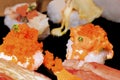 Sushi Set Sashimi and sushi rolls served on black stone slate. Royalty Free Stock Photo