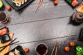 Sushi set sashimi and sushi rolls around dark background Royalty Free Stock Photo