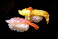 Sushi Set Sashimi and sushi rolls served on black stone slate. Royalty Free Stock Photo