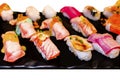 Sushi Set sashimi and sushi rolls served on black stone slate. Royalty Free Stock Photo