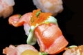 Sushi Set Sashimi and sushi rolls served on black stone slate. Royalty Free Stock Photo