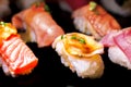 Sushi Set Sashimi and sushi rolls served on black stone slate. Royalty Free Stock Photo