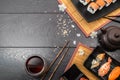 Sushi set sashimi and sushi rolls and white flowers on dark background Royalty Free Stock Photo