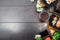 Sushi set sashimi and sushi rolls and white flowers on dark background Royalty Free Stock Photo