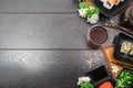 Sushi set sashimi and sushi rolls and white flowers on dark background Royalty Free Stock Photo