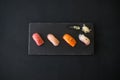 Sushi set served on black tray.
