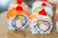 Sushi set, sushi roll with salmon and sushi roll with avocado.