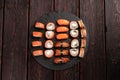 Sushi set from top on black background top view. An assortment of various maki nigiri and rolls seafood soy sauce Royalty Free Stock Photo