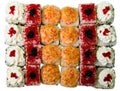 Sushi set on a white background, isolate, top view. Sushi rolls with cottage cheese, sesame, fish, chicken and caviar