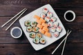 Sushi set on white plate with sauce and chopsticks Royalty Free Stock Photo