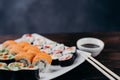 Sushi set on white plate with sauce and chopsticks Royalty Free Stock Photo