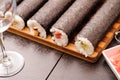 sushi on the wooden table. Empty glass for wine Royalty Free Stock Photo