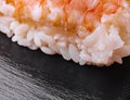 Sushi shrimp and rice on a black wood