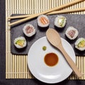 Sushi slate table with chopsticks and hot sauce and soy sauce on bamboo rubber Royalty Free Stock Photo