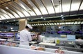 Sushi on a sliding rail and Japanese food chef in a Japanese restaurant in a shopping mall at Sukhumvit road Bangkok Thailand