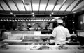 Sushi on a sliding rail and Japanese food chef in a Japanese restaurant in a shopping mall at Sukhumvit road Bangkok Thailand