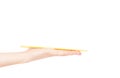 Sushi sticks asian in female hand on a white background