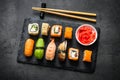 Sushi and sushi roll set on black stone table top view Royalty Free Stock Photo