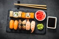 Sushi and sushi roll set on black stone table top view Royalty Free Stock Photo