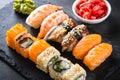 Sushi and sushi roll set on black stone table. Royalty Free Stock Photo