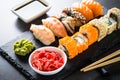 Sushi and sushi roll set on black stone table. Royalty Free Stock Photo