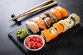 Sushi and sushi roll set on black stone table. Royalty Free Stock Photo