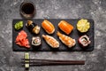 Sushi and sushi rolls, sushi nigiri on stone plate on dark background, mustard wasabi Royalty Free Stock Photo