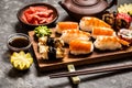 Sushi and sushi rolls, sushi nigiri on stone plate on dark background, mustard wasabi Royalty Free Stock Photo