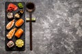 Sushi and sushi rolls, sushi nigiri on stone plate on dark background, mustard wasabi Royalty Free Stock Photo