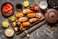 Sushi and sushi rolls, sushi nigiri on stone plate on dark background Royalty Free Stock Photo