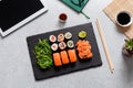 Sushi takeaway at work desk with laptop overhead. Eating sushi for lunch break at office, lunch meal at work, top view Royalty Free Stock Photo