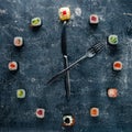 Sushi clock with fork and knife, concept of time to eat Royalty Free Stock Photo