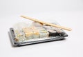 Sushi to go in a black takeaway box with wooden chopsticks on white background Royalty Free Stock Photo