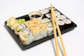 Sushi to go in a black takeaway box with wooden chopsticks on white background Royalty Free Stock Photo