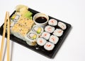 Sushi to go in a black takeaway box with wooden chopsticks on white background Royalty Free Stock Photo