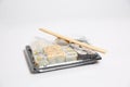 Sushi to go in a black takeaway box with wooden chopsticks on white background Royalty Free Stock Photo