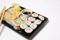 Sushi to go in a black takeaway box with wooden chopsticks on white background Royalty Free Stock Photo