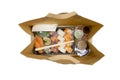 Sushi to go concept. Top view of takeaway box with sushi rolls and various sauce cups in brown paper bag. Royalty Free Stock Photo