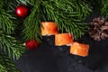 Sushi top view, Philadelphia Japanese rolls with salmon, fir branches, cones, red Christmas balls