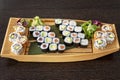 Sushi tray in the shape of a Japanese wooden boat with uramaki Royalty Free Stock Photo