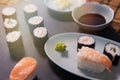 sushi on a tray and the slate, next to a bowl full of soy sauce, rice, salmon Royalty Free Stock Photo