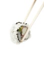 Sushi uramaki, inside out, california roll with chop sticks.