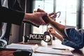 Suspect with handcuffs being interviewed in interrogation room by Police officer, Criminal law concept Royalty Free Stock Photo