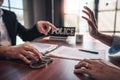 Suspect with handcuffs being interviewed in interrogation room by Police officer, Criminal law concept Royalty Free Stock Photo