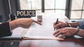 Suspect with handcuffs being interviewed in interrogation room by Police officer, Criminal law concept Royalty Free Stock Photo