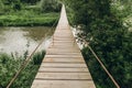 Suspended cable bridge over river wooden floor Royalty Free Stock Photo