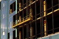 Suspended construction craddle near wall of hightower building with ventilated facade on construction site. Engineering urban