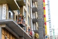 Suspended construction craddle near wall of hightower residentaial building with glass metal modern facade construction Royalty Free Stock Photo