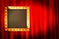 Suspended gold frame on the red curtain Royalty Free Stock Photo