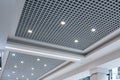 Suspended and grid ceiling with halogen spots lamps and drywall construction in empty room in store or house. Stretch ceiling